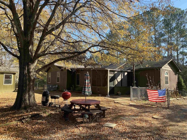 back of property with glass enclosure