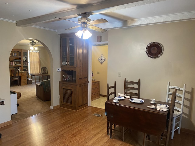 dining room with beam ceiling, ceiling fan, hardwood / wood-style floors, and ornamental molding