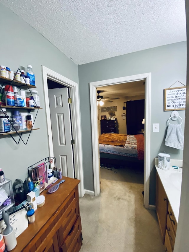 carpeted office with ceiling fan and a textured ceiling