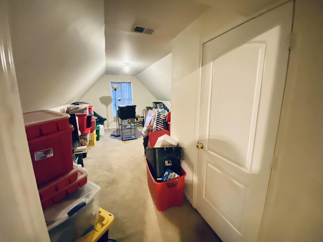 interior space featuring carpet and vaulted ceiling