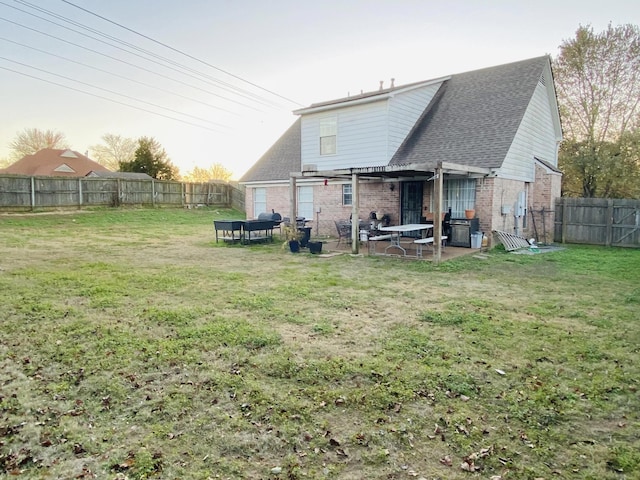 back of house with a lawn