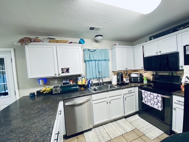 kitchen with white cabinetry, sink, light tile patterned floors, and black appliances