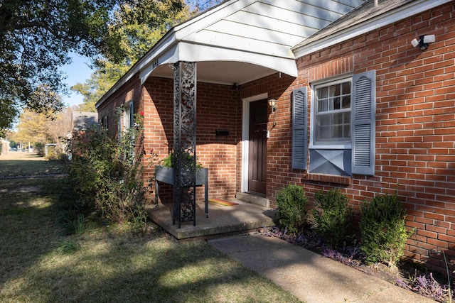 doorway to property featuring a lawn