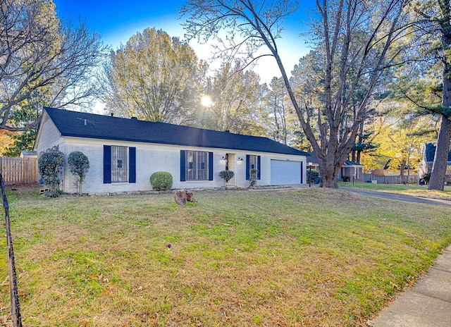 ranch-style house with a garage and a front lawn