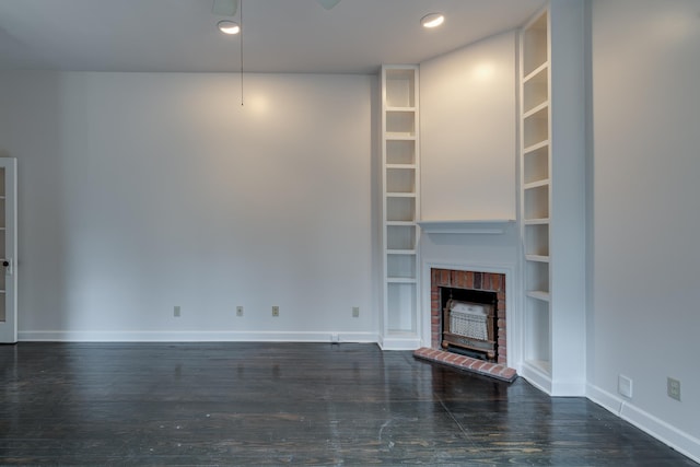 unfurnished living room featuring built in shelves and a fireplace