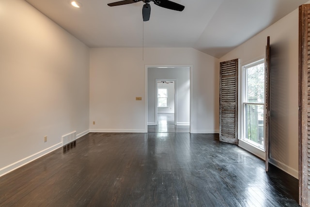 spare room featuring vaulted ceiling, ceiling fan, and dark hardwood / wood-style floors