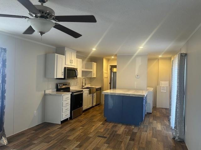 kitchen with white cabinets, dark hardwood / wood-style floors, a center island, and stainless steel appliances