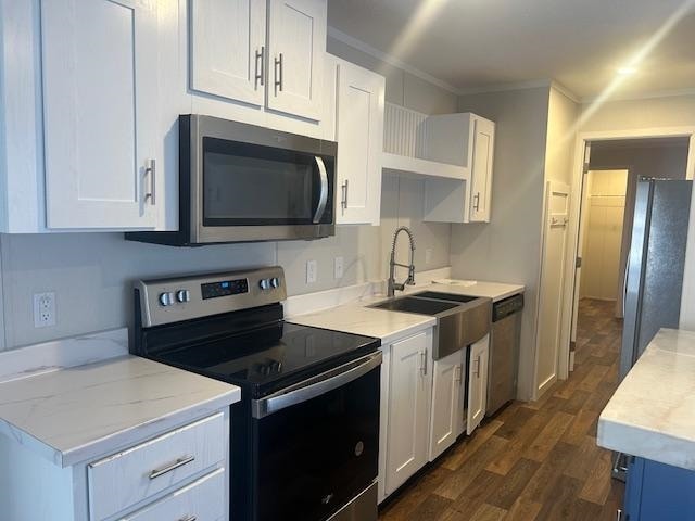 kitchen featuring stainless steel appliances, white cabinetry, dark hardwood / wood-style floors, and sink