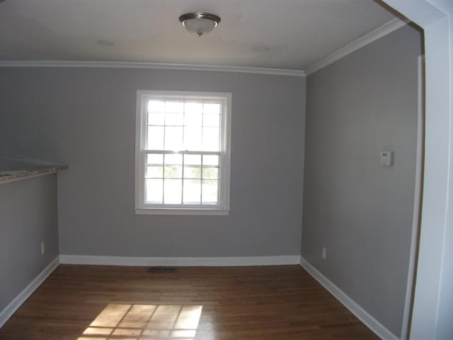 unfurnished room with dark hardwood / wood-style floors and crown molding