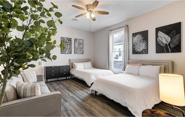 bedroom with ceiling fan and dark wood-type flooring