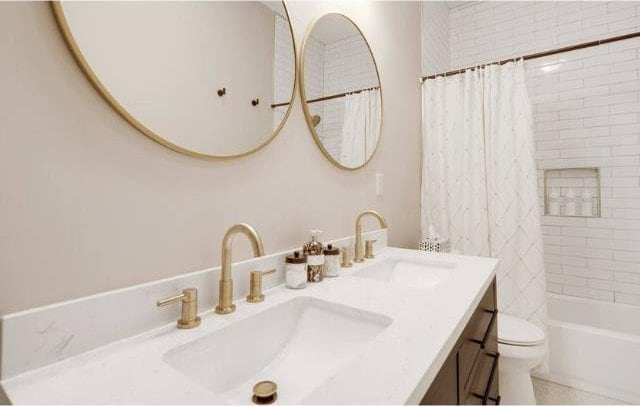 full bathroom featuring vanity, toilet, and shower / bath combo with shower curtain