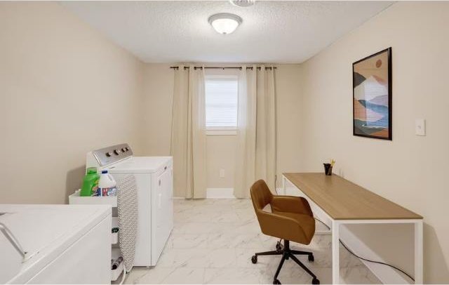 office area with washer and clothes dryer and a textured ceiling