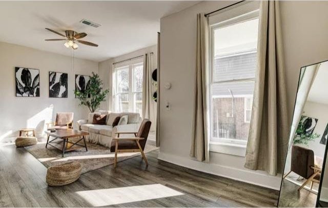 sitting room with dark hardwood / wood-style floors and ceiling fan