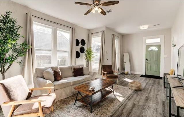 living room featuring ceiling fan and hardwood / wood-style floors