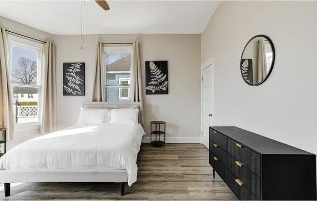 bedroom with ceiling fan and dark wood-type flooring