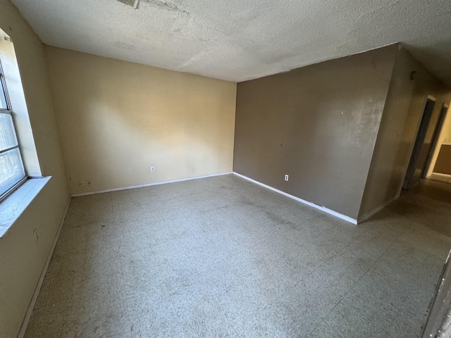 empty room featuring a textured ceiling