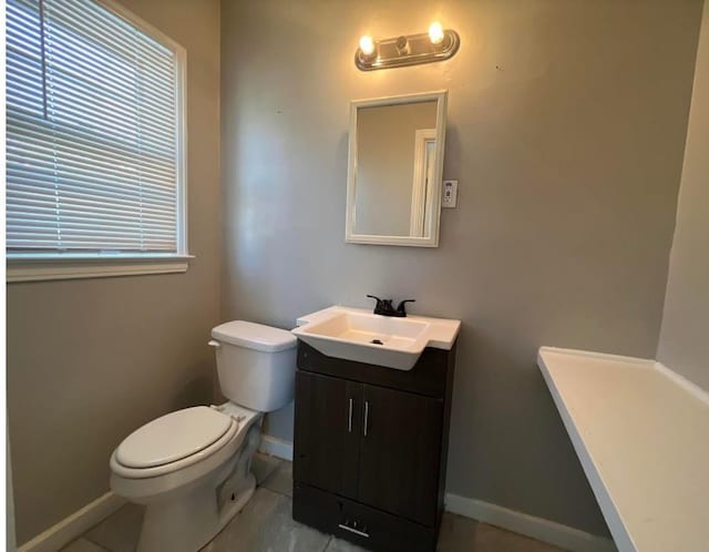 bathroom with tile patterned floors, vanity, and toilet