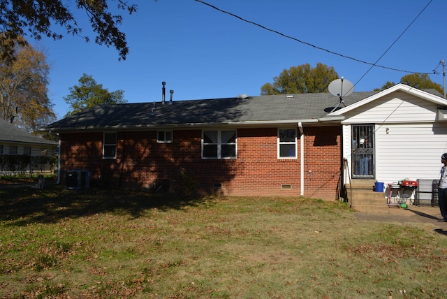 back of house with central AC and a lawn