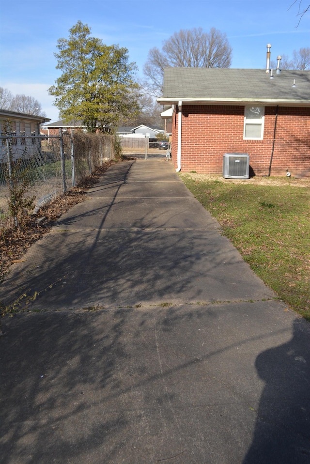 view of side of home with central air condition unit