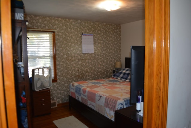 bedroom with dark wood-type flooring