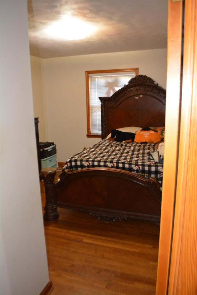 bedroom with hardwood / wood-style floors