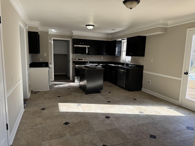 kitchen with appliances with stainless steel finishes, a center island, ornamental molding, and sink