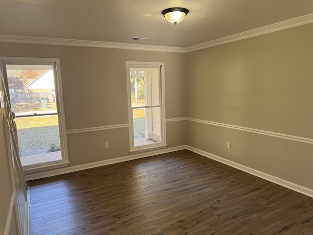 empty room featuring dark hardwood / wood-style flooring and ornamental molding