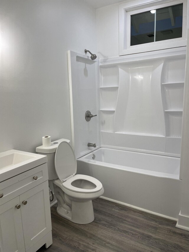 full bathroom with shower / tub combination, vanity, wood-type flooring, and toilet