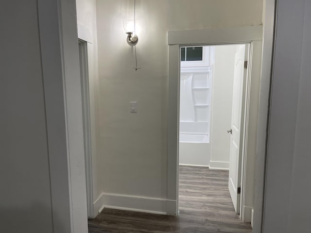 hallway with dark wood-type flooring