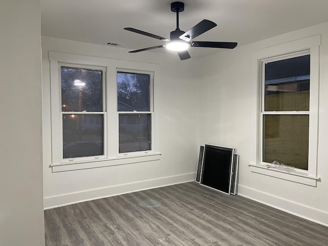 unfurnished room featuring dark hardwood / wood-style floors and ceiling fan