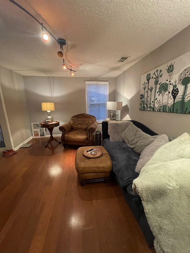 living room featuring a textured ceiling and hardwood / wood-style flooring