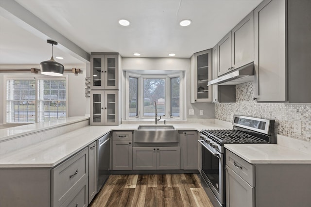 kitchen with gray cabinetry, sink, and stainless steel appliances