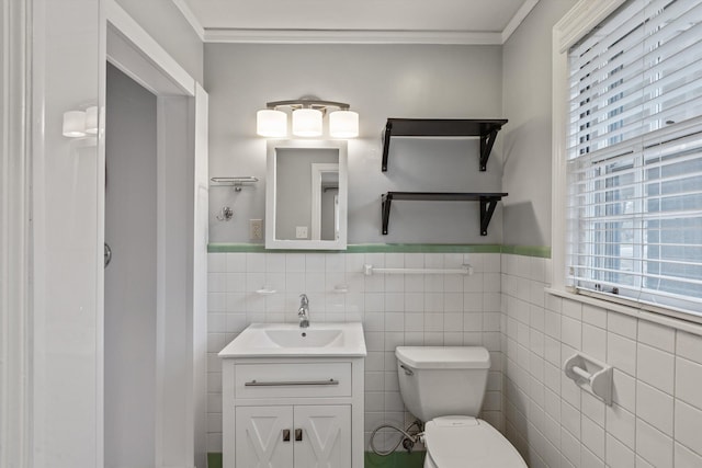 bathroom featuring vanity, a healthy amount of sunlight, and tile walls