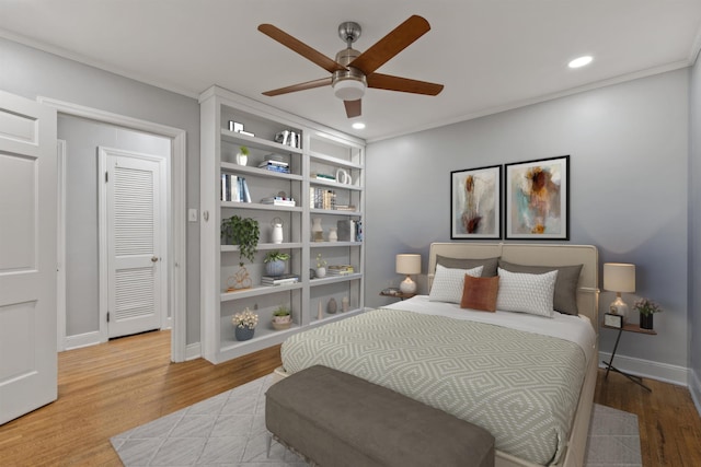 bedroom with hardwood / wood-style floors, a closet, and ceiling fan