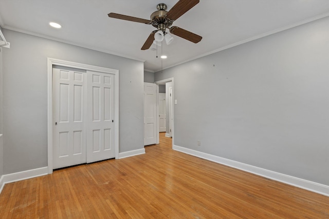 unfurnished bedroom featuring ceiling fan, light hardwood / wood-style floors, ornamental molding, and a closet