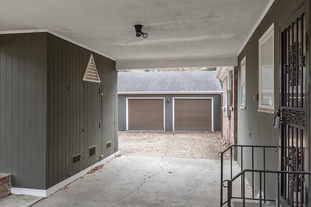 view of patio / terrace with an outbuilding and a garage