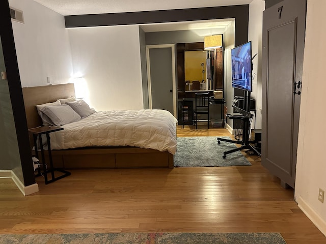 bedroom featuring wood-type flooring