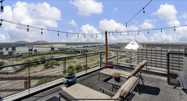 view of patio / terrace with a balcony and a water view