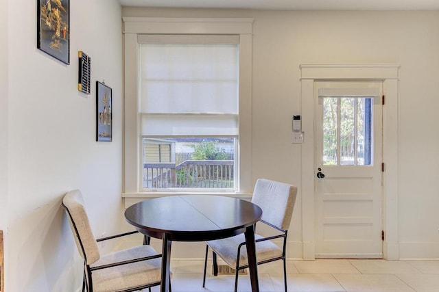 dining space featuring light tile patterned flooring