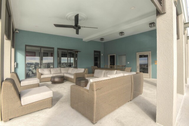 living room featuring ceiling fan, beam ceiling, and light carpet