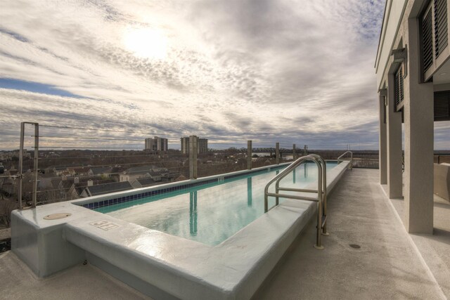 view of pool at dusk