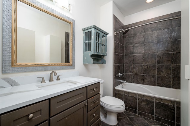 full bathroom featuring tile patterned flooring, tiled shower / bath combo, toilet, and vanity