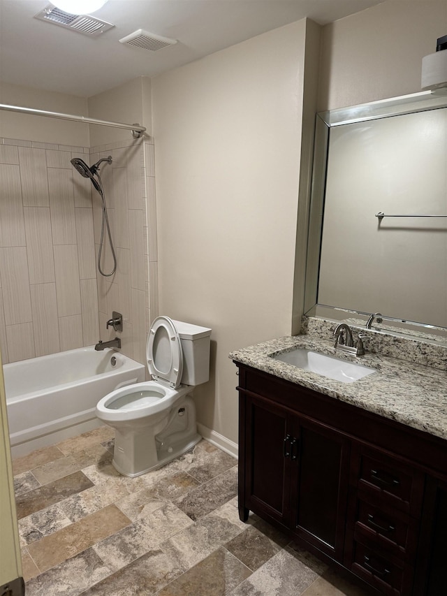 full bathroom featuring tiled shower / bath combo, toilet, and vanity