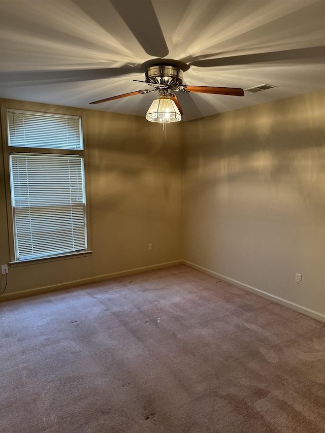 unfurnished room with ceiling fan and carpet floors