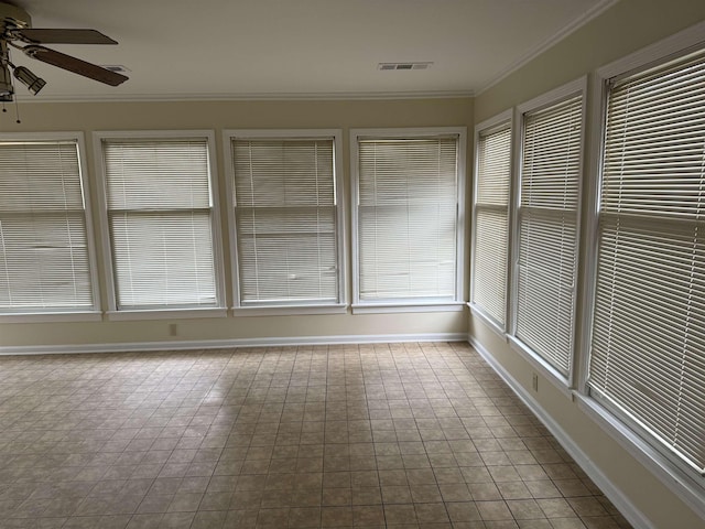 unfurnished sunroom with ceiling fan and a healthy amount of sunlight