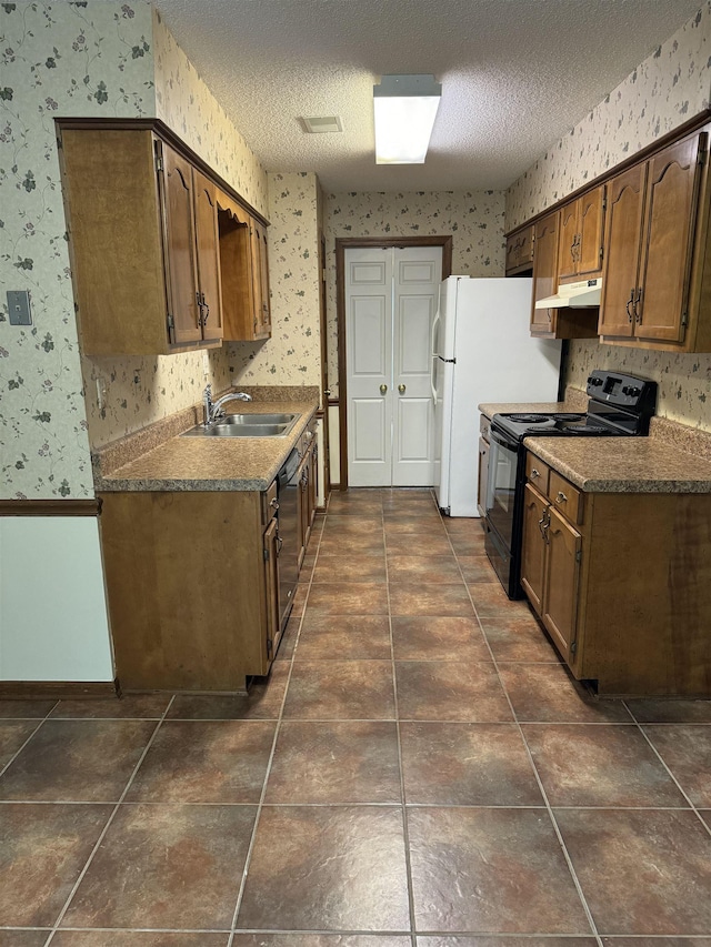 kitchen featuring dishwasher, sink, dark tile patterned floors, a textured ceiling, and black range with electric cooktop