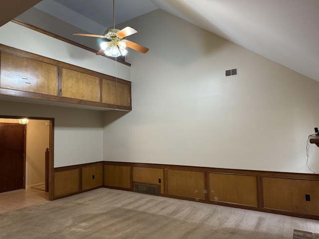 kitchen with ceiling fan, high vaulted ceiling, and light colored carpet