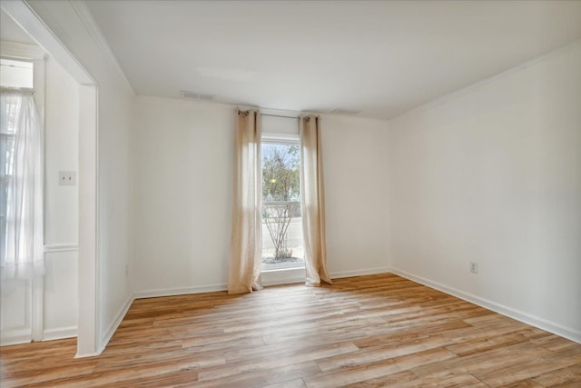 unfurnished room featuring light hardwood / wood-style flooring and ornamental molding