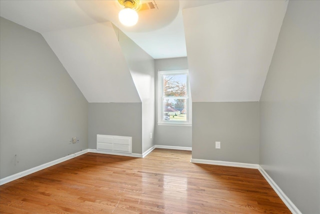 bonus room featuring vaulted ceiling and light wood-type flooring