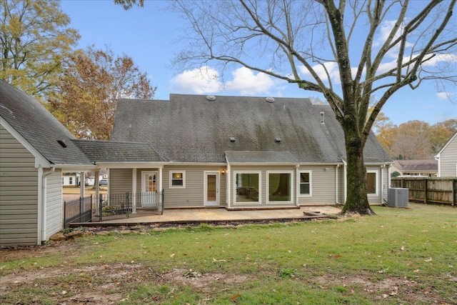 rear view of house featuring a yard, a patio, and cooling unit